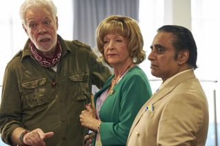 Gregor (Matthew Kelly), Ursula (Charlie Hardwick) and Gwyn (Sanjeev Bhaskar) stand in the function room of the rugby club