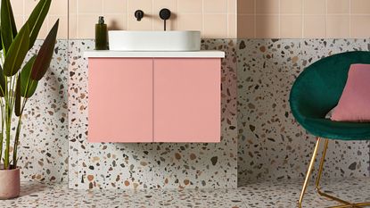 Terrazzo tiles on floor and wall, and floating pink sink unit