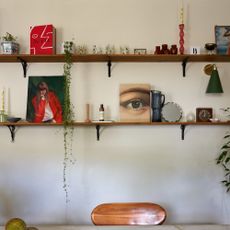 A kitchen with open shelving displaying various decorative objects