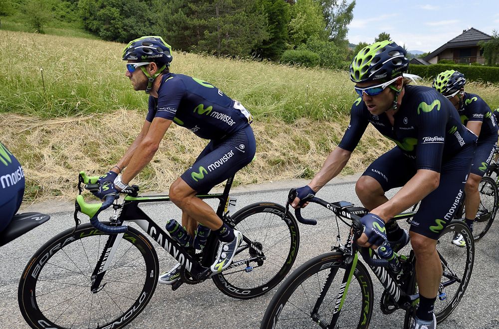 Alejandro Valverde (L) and Britain's Alex Downsett (R) ride in the pack during the 131.5 km first stage of the 67th edition of the Criterium Dauphine.