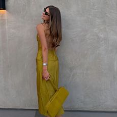 Sara Walker in a tennis ball green Tibi dress and Khaite bag
