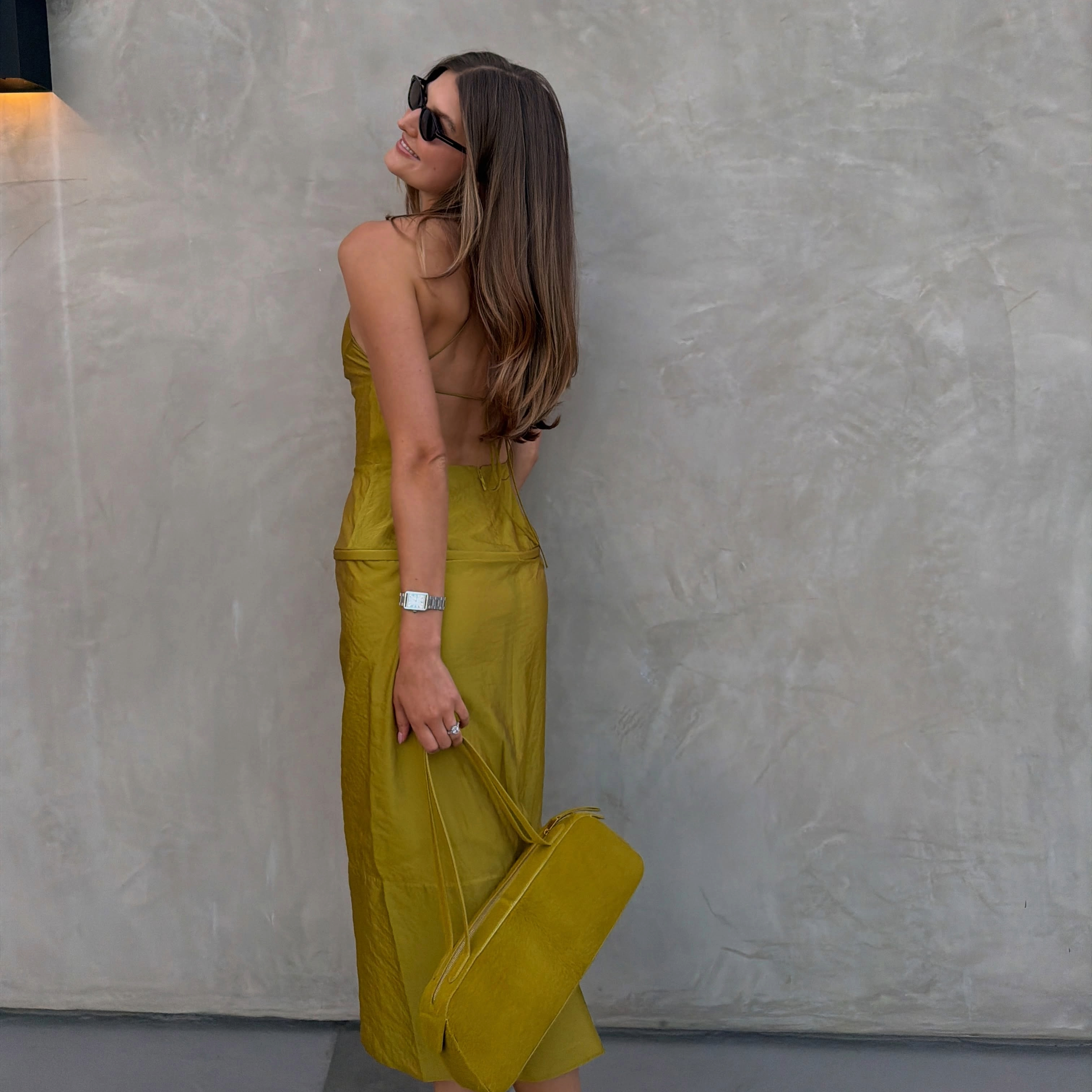 Sara Walker in a tennis ball green Tibi dress and Khaite bag