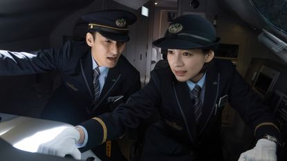 A couple of train crew look on in fear in Bullet Train Explosion.
