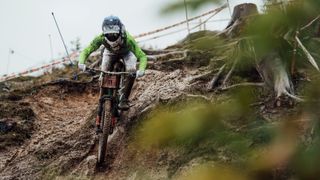 A rider descends a muddy, rooty trail at the UCI Mountain Bike World Championships 2020 Leogang, Austria