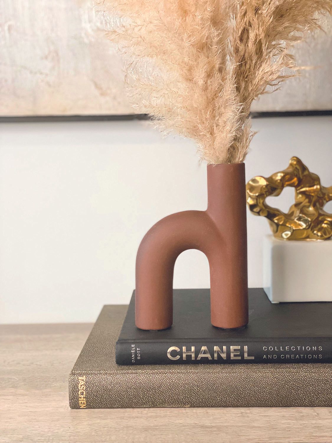 red clay pottery placed atop books