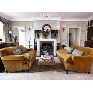 royal suite sitting room with bluebell three seater sofa in saffron smart velvet and fireplace
