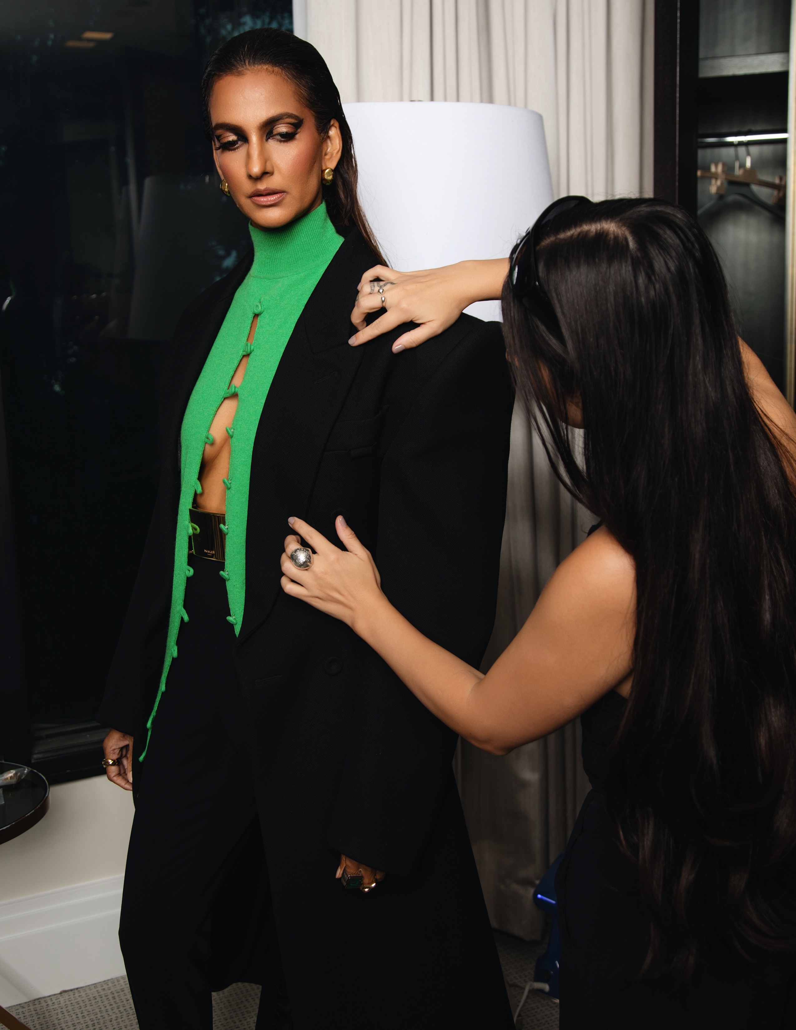 Poorna Jagannathan getting ready for the premiere of 'Lanterns' in L.A., wearing a black-and-green cool from Mugler.