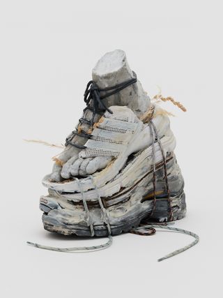 Recycled clog-style shoes, cement, yarn, rope and cork,