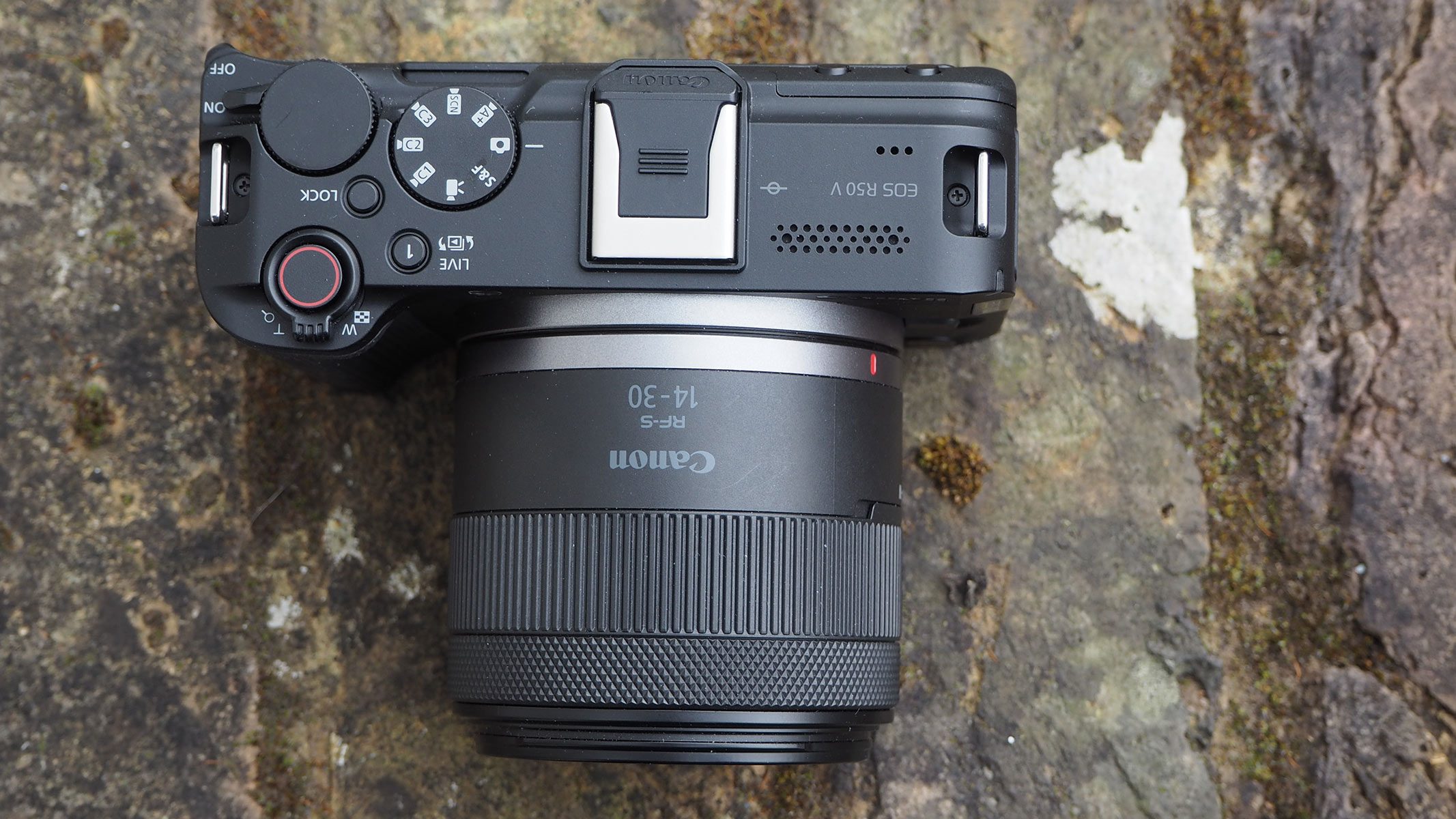 A bird's eye view of the Canon EOS R5 V on a stone wall.