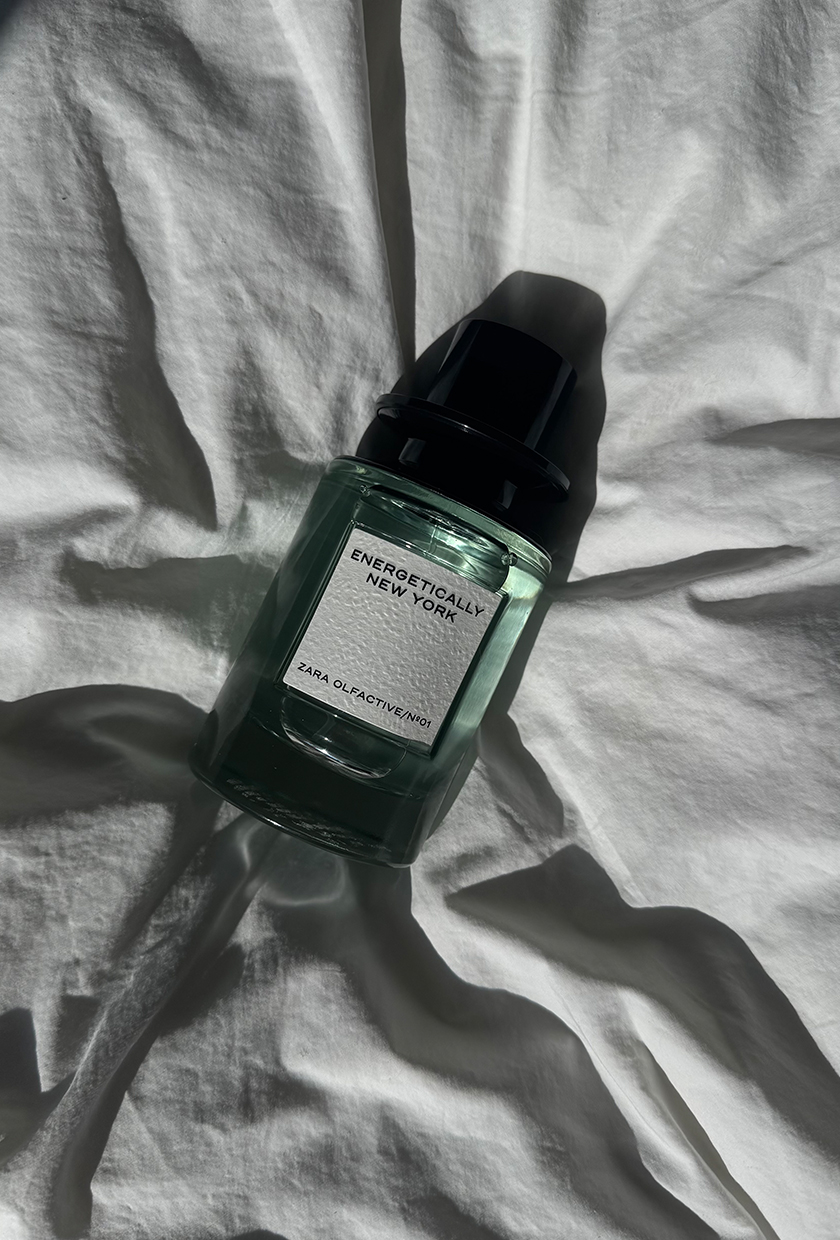 A picture of Zara Energetcially New York perfume on a white sheet of fabric