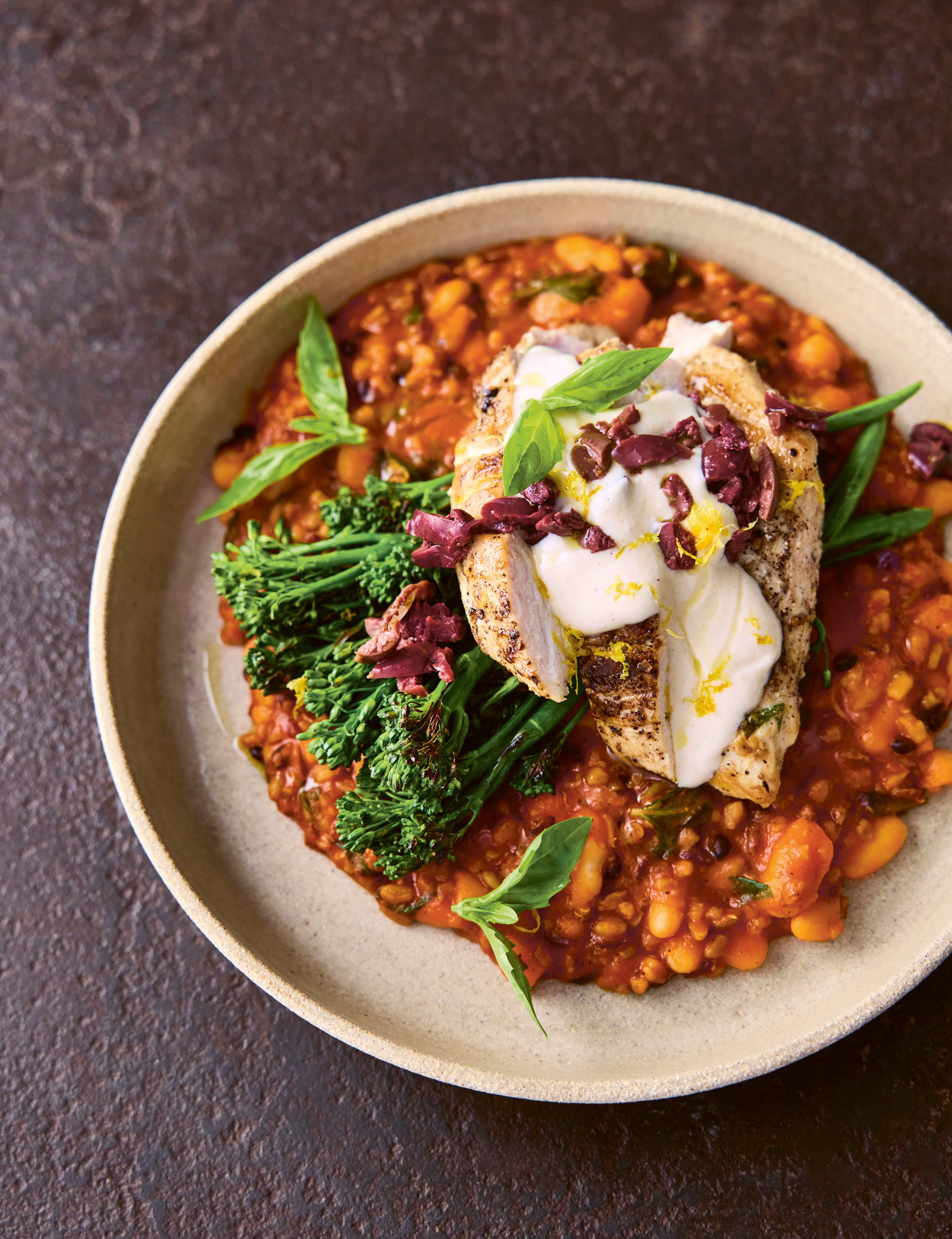 A plate of chicken with broccoli, beans and grains
