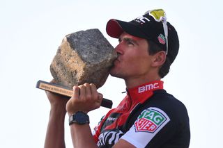 Greg van Avermaet holds the cobbled trophy of Paris Roubaix aloft in 2017