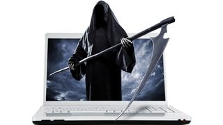 The Grim Reaper looms out of a laptop.