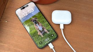 iPhone 15 Pro shown charging AirPods 2 using USB-C