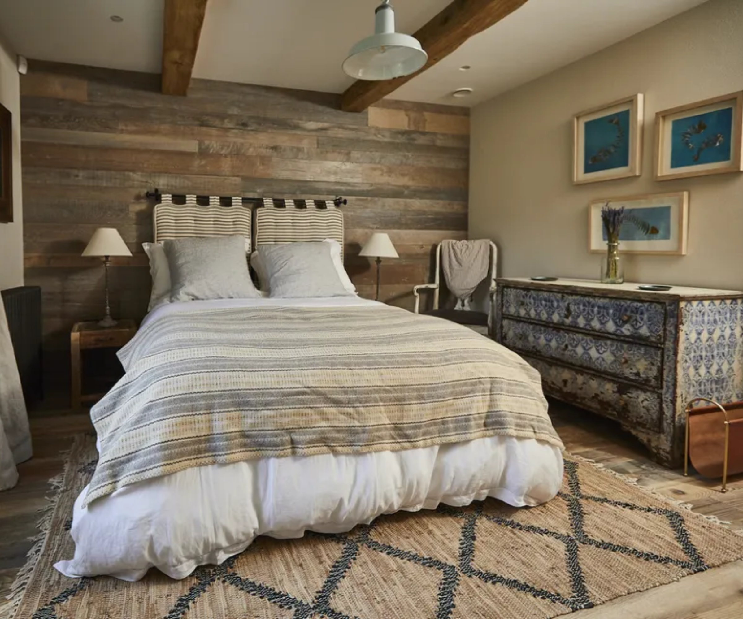 bedroom in a barn conversion with varied lighting design plan and timber cladding