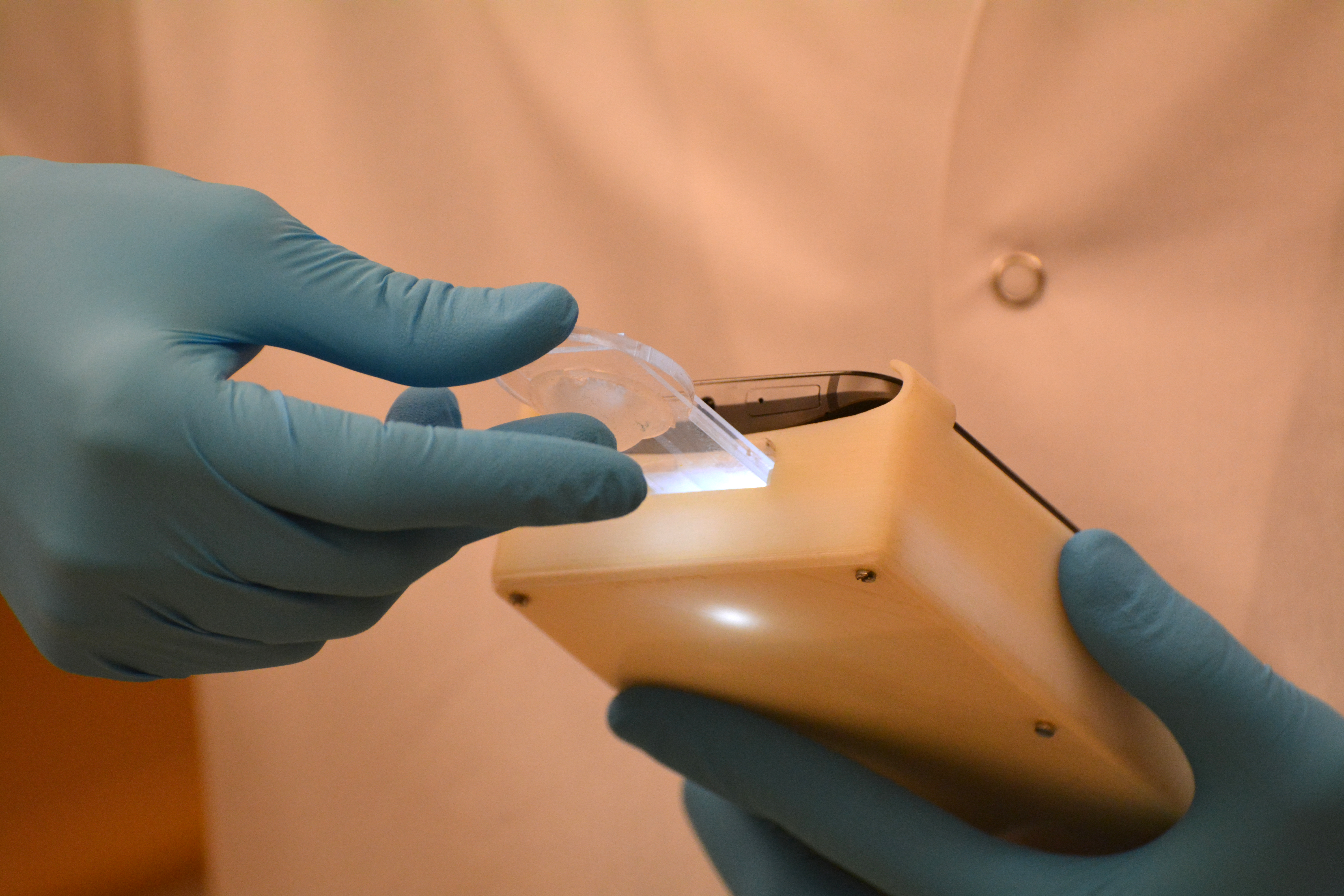 A technician operates a smartphone device that can detect abnormal semen samples with 98 percent accuracy.