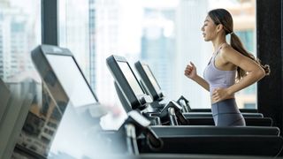 Woman running on a treadmill at a gym