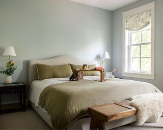 calming bedroom with light blue walls and sage green bedding