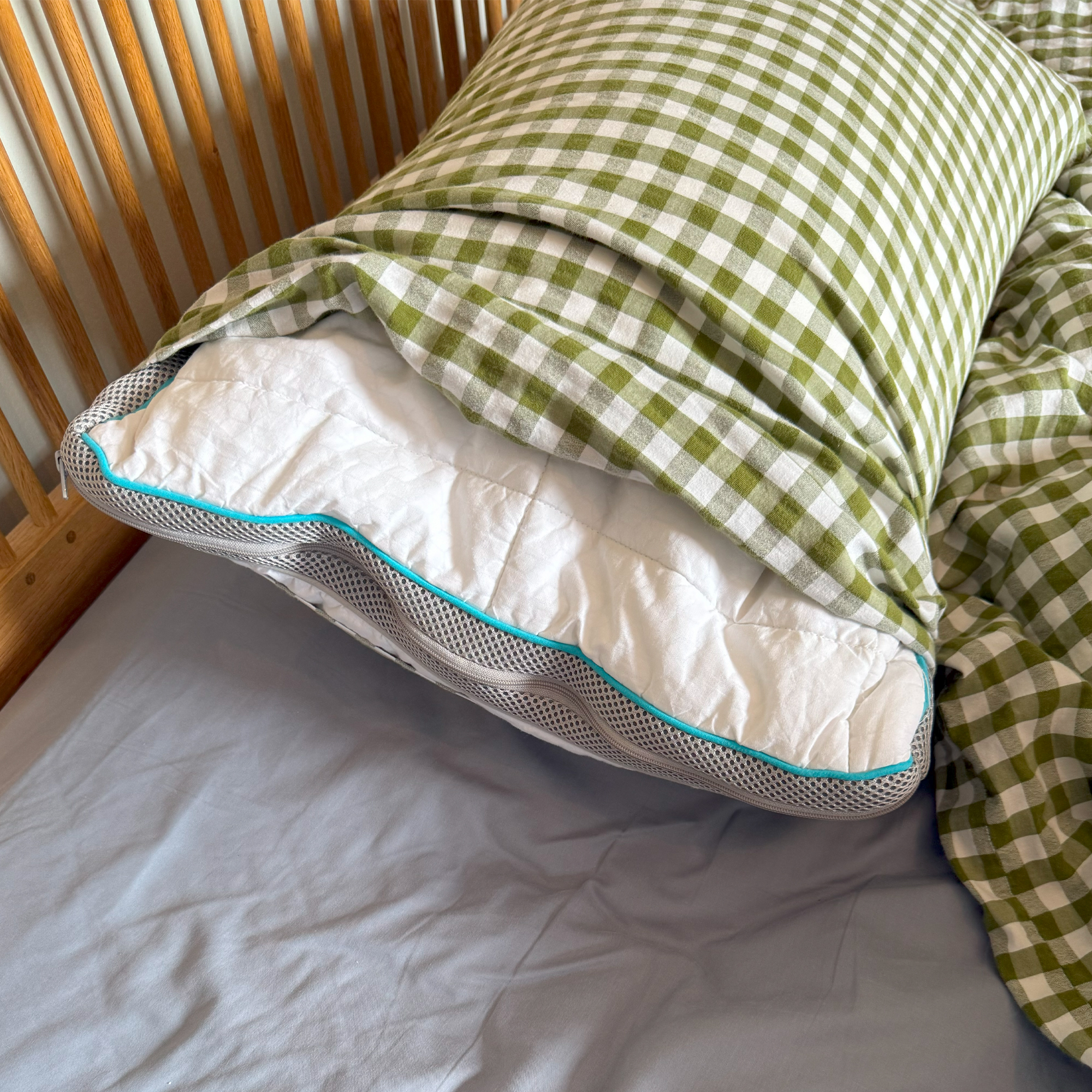 The Simba Hybrid Firm pillow in a green gingham pillowcase