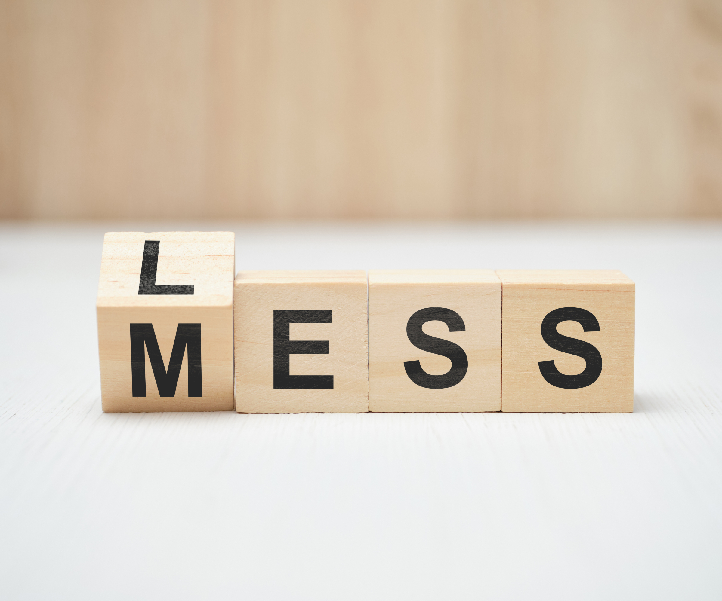 wooden blocks with letters on saying less mess