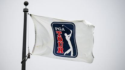 A PGA Tour flag being blown about in strong winds