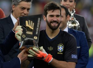 Brazil's Alisson Becker with his Best Goalkeeper award at the 2019 Copa America.