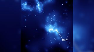 A view of Sagittarius A*, bright blue streaks against a black background of space. 