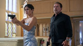 Emma (Monica Barbaro) and Luke Brunner (Arnold Schwarzenegger) in a church armed with pistols in FUBAR season 1