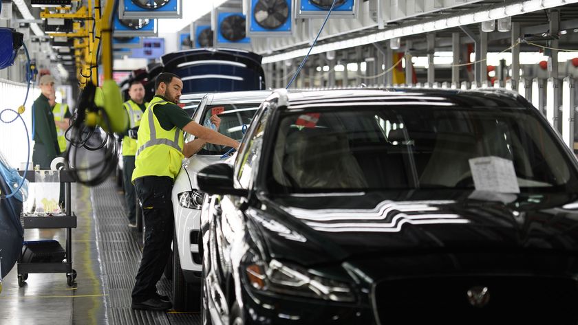 Workers at a Jaguar Land Rover factory production line.