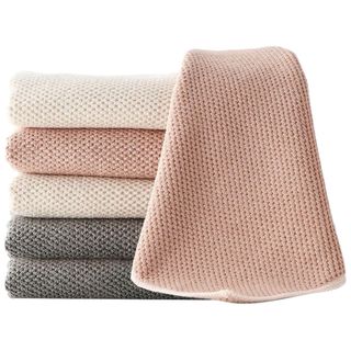 A stack of grey, beige and pink textured barista towels