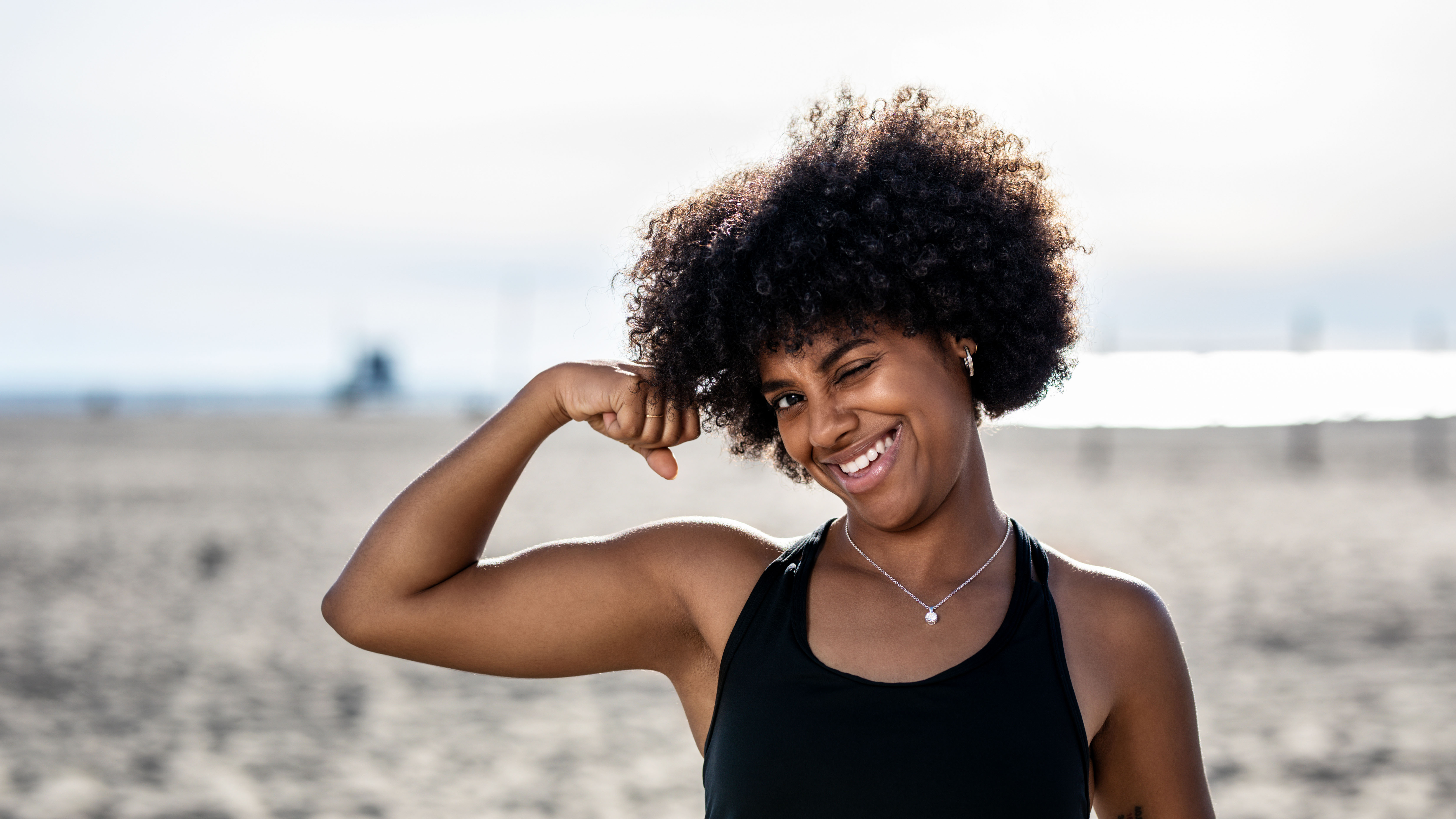 Young woman flexing bicep