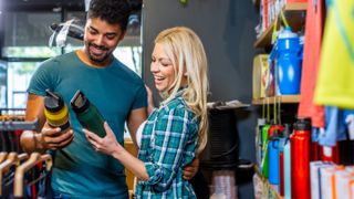 Man and woman shopping for reusable water bottles