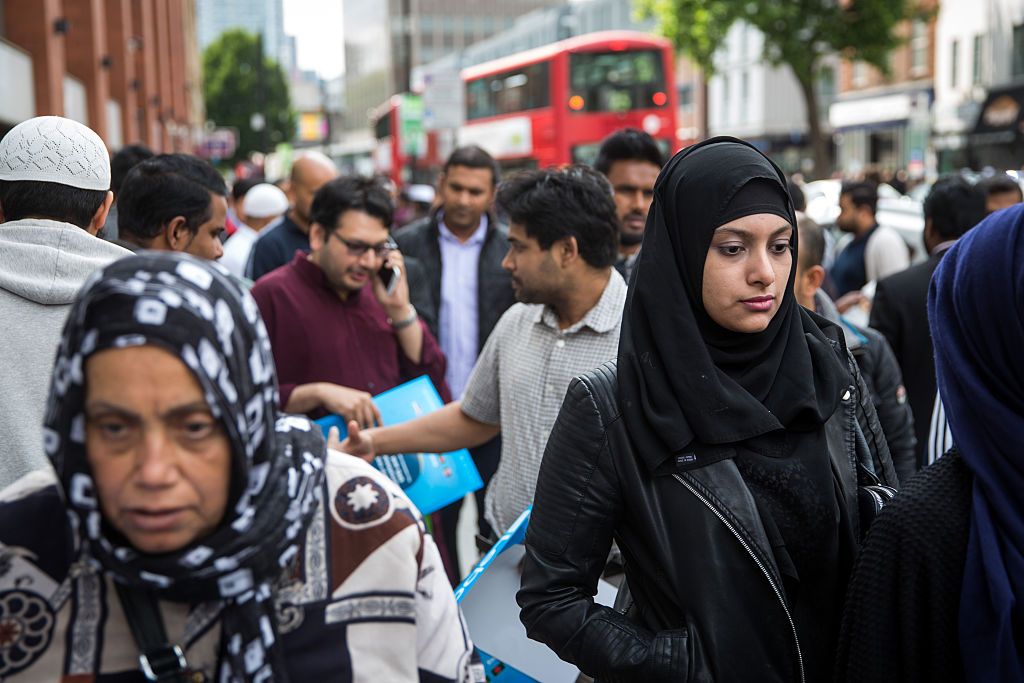 People leave the East London Mosque after prayers