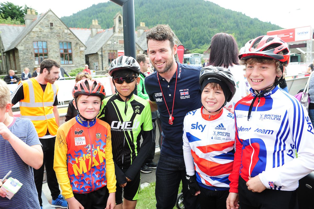 Mark Cavendish poses for photographs with fans at the national time trial championships