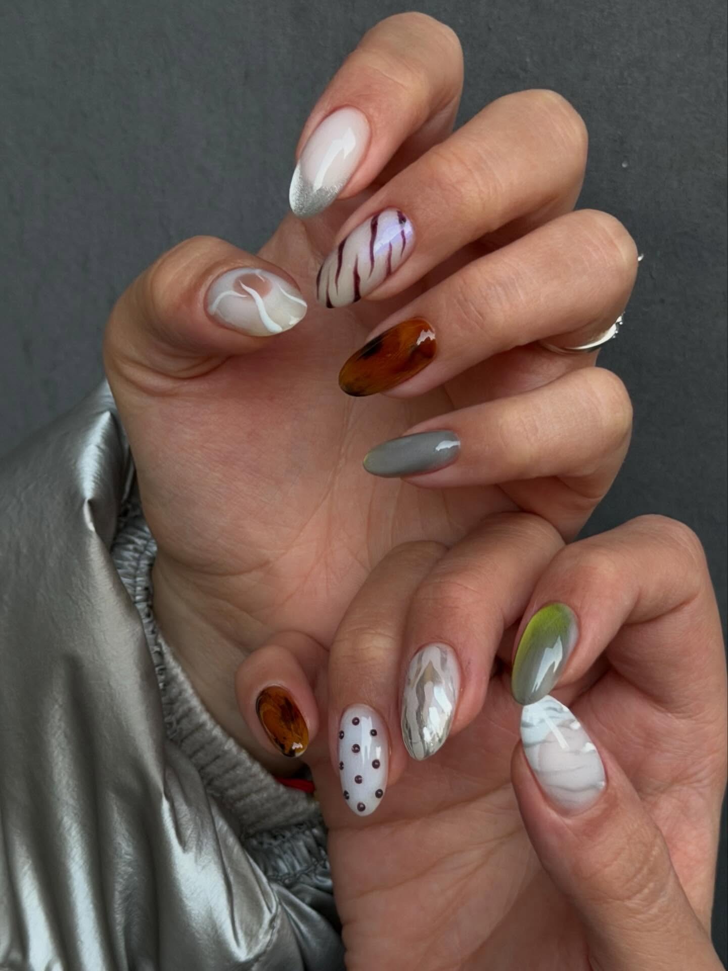 Chrome zebra and tiger stripe nail art.