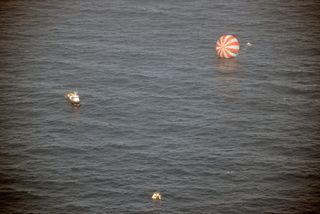 Recovery boats approach Dragon after splashdown into the Pacific Ocean on March 26, 2013. Dragon returned from the International Space Station.