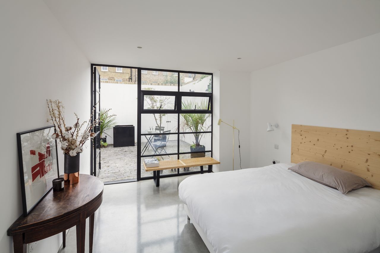 The living accommodation along with the guest bedroom (above) open out onto the new outdoor courtyard area through Belgian doors.