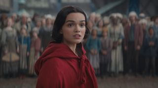 Snow White (Rachel Zegler) wearing a red cloak in a scene from Disney's live-action "Snow White" remake