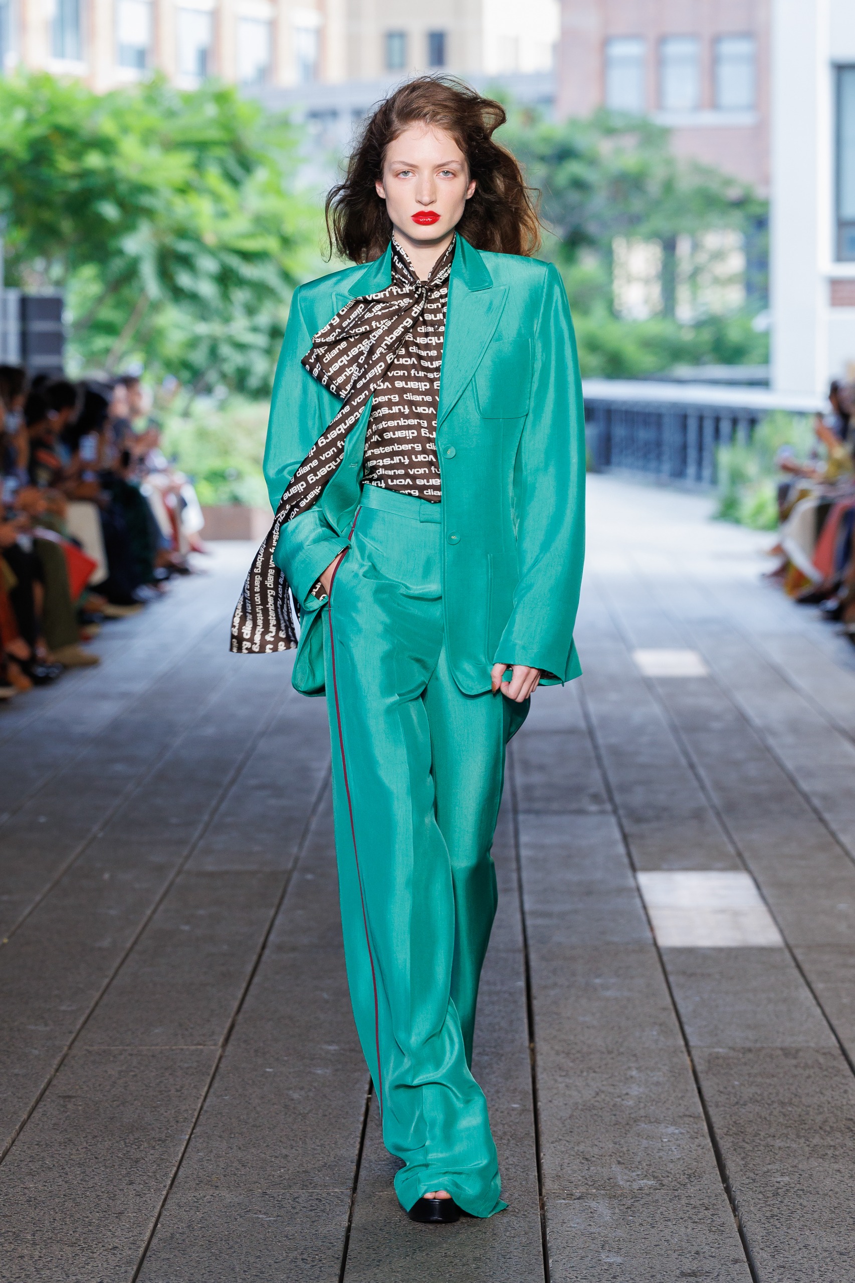 A model wearing a turquoise suit on the DVF Spring 2027 runway at New York Fashion Week.