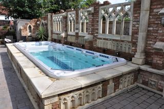 Above ground swimming pool with brickwork surrounding it