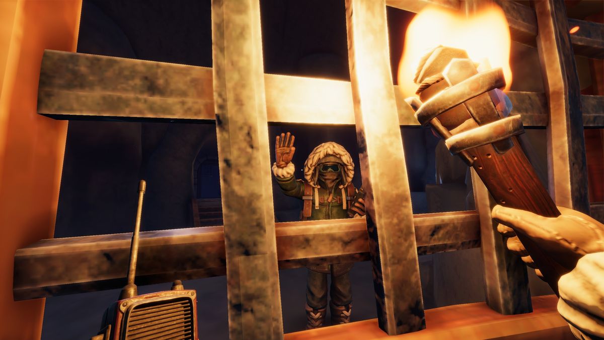 We Were Here Forever - A player holds a torch while looking at another player waving from the opposite side of a metal gate.