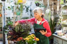 Senior woman working in a garden shop.