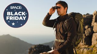 Man with binoculars on a mountain top for the binoculars deals hub