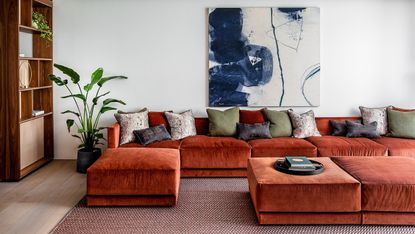 a living room with a large red sofa
