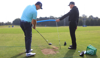 Padraig Harrington works with his coach on the driving range