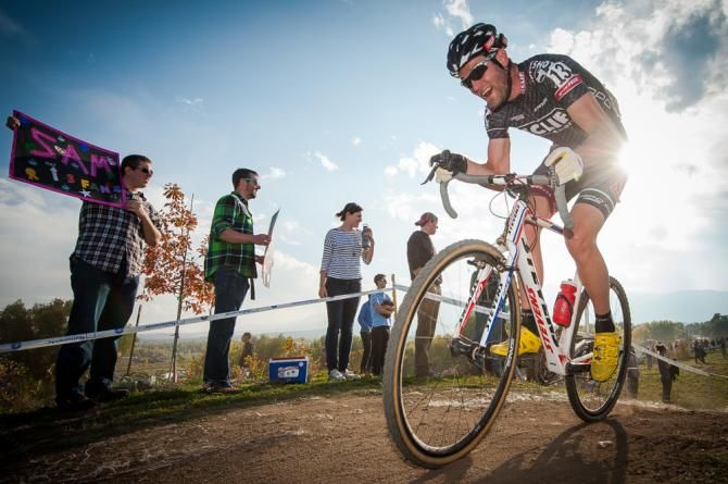 A Cliff Bar rider shows the pain face of the race as a Sam fan looks for his rider. Boulder Cup.