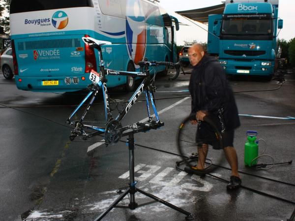 Team mechanic Geoff Brown gets to work cleaning Tyler Farrar's bike.