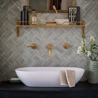 bathroom with grey tiles and white sink