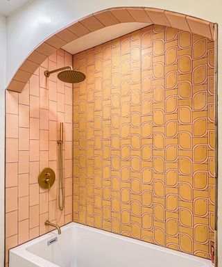Shower nook decorated with orange and pink tiles from Clay Imports