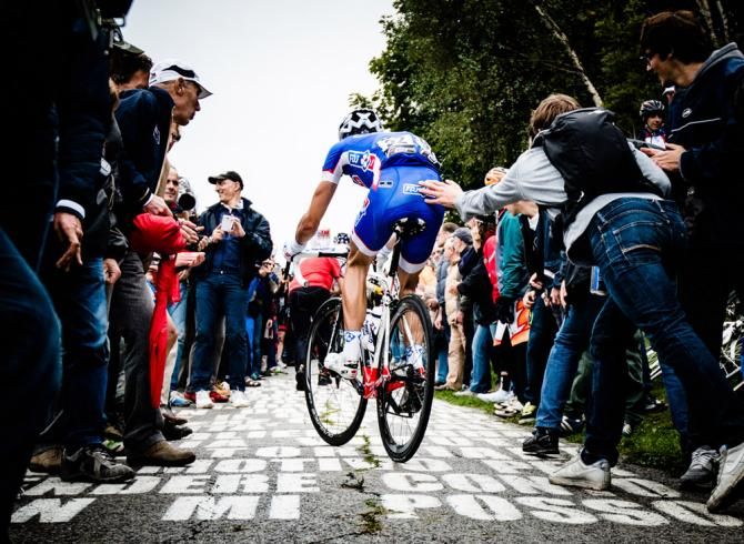 An FDJ rider gets a push on the infamous ascent of the Muro di Sormano.